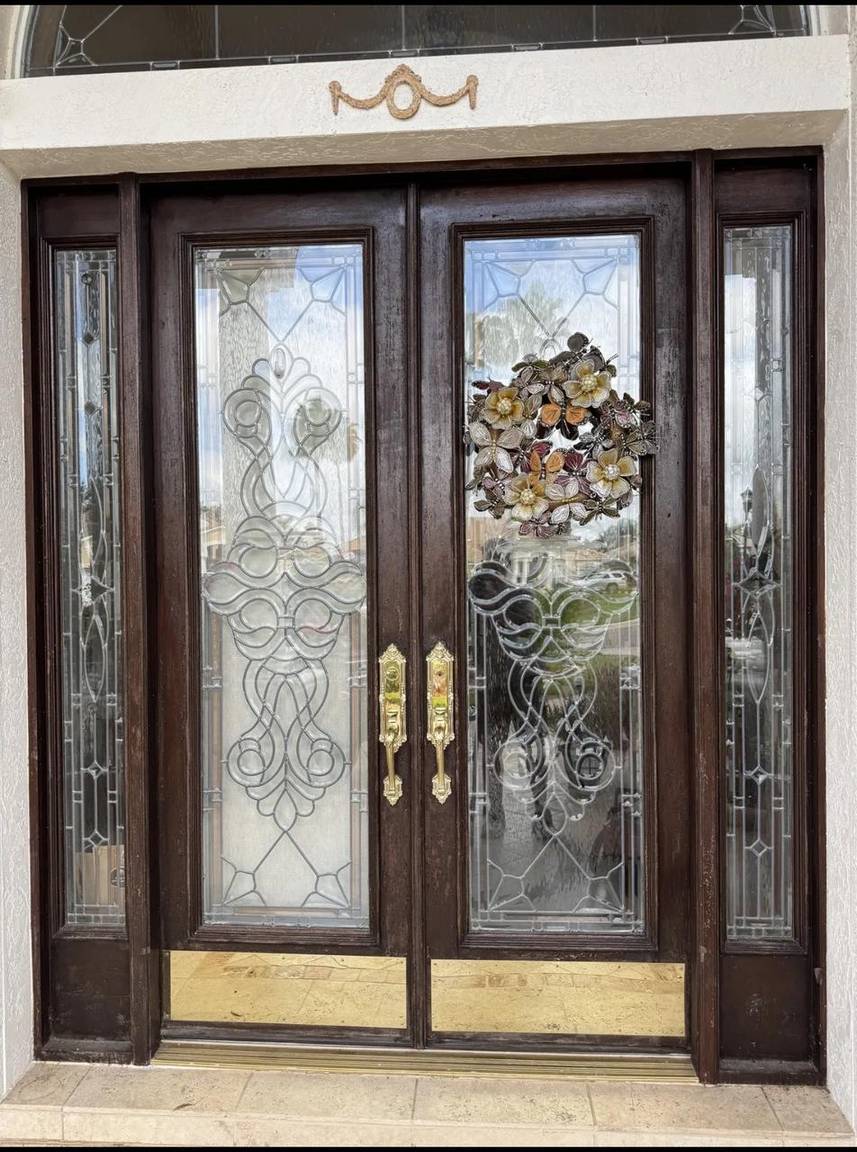 Double entry doors before restoration with faded, worn finish