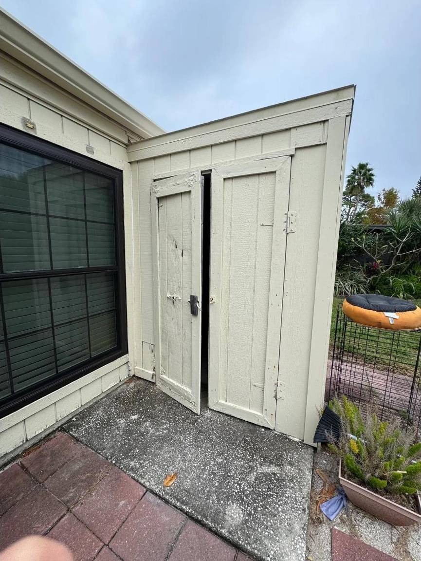 Old weathered outdoor storage doors before replacement