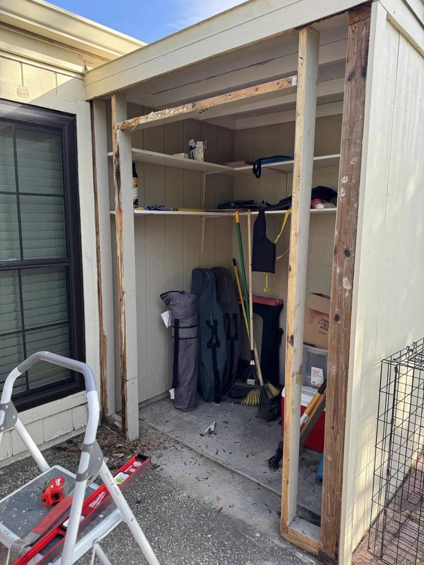 Storage opening cleared with exposed framing during door replacement