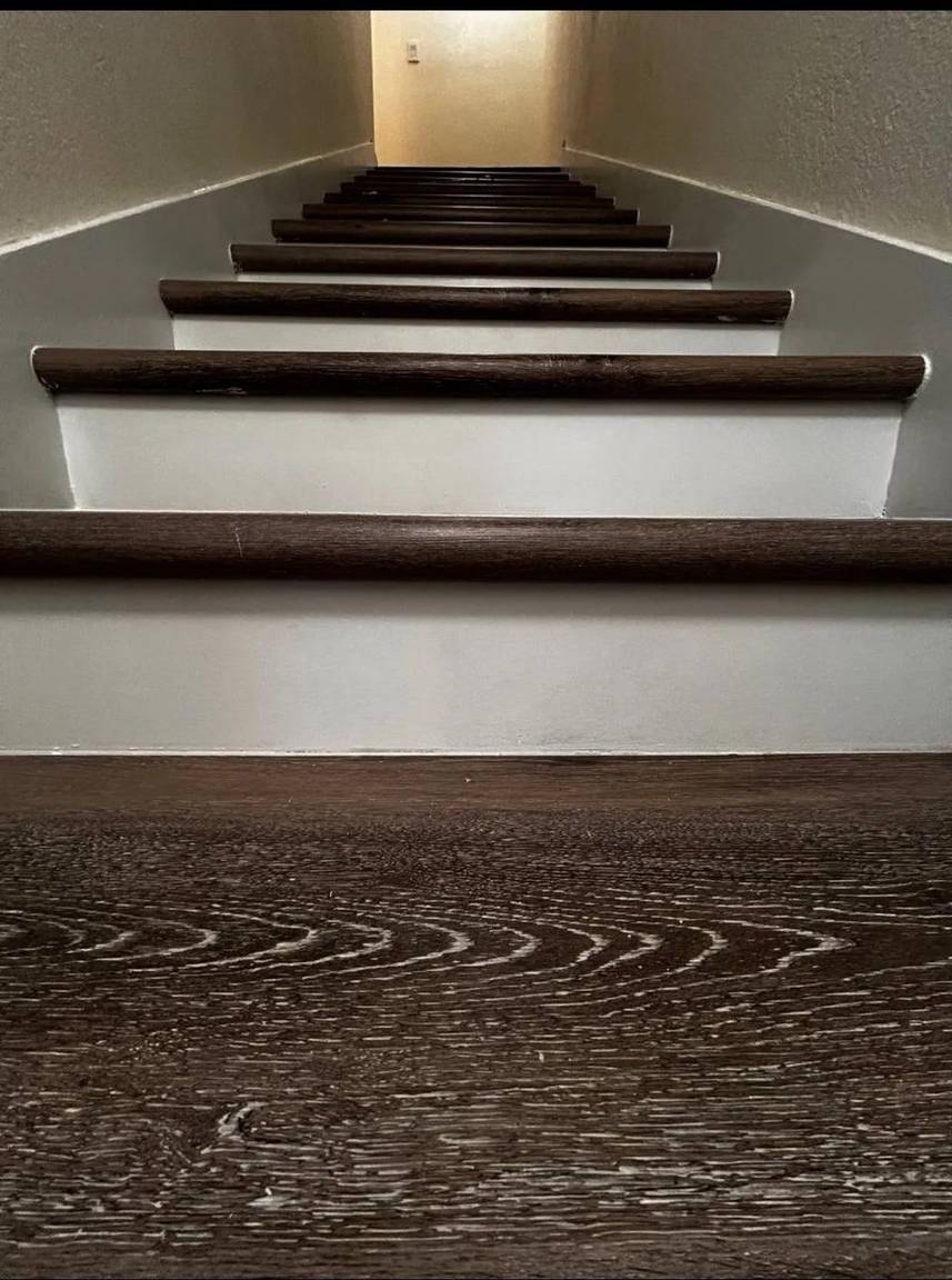 Finished staircase with dark luxury vinyl treads and white risers