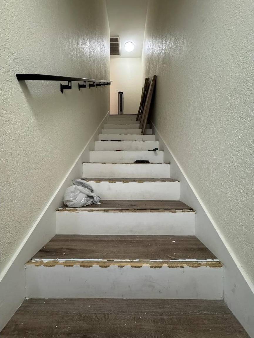 Staircase mid-renovation with new vinyl treads partially installed